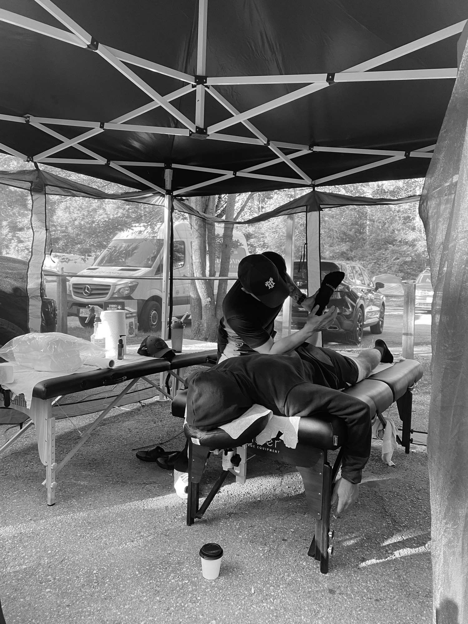 HyperTherapy RMT giving a chair massage to a guest at an outdoor client event