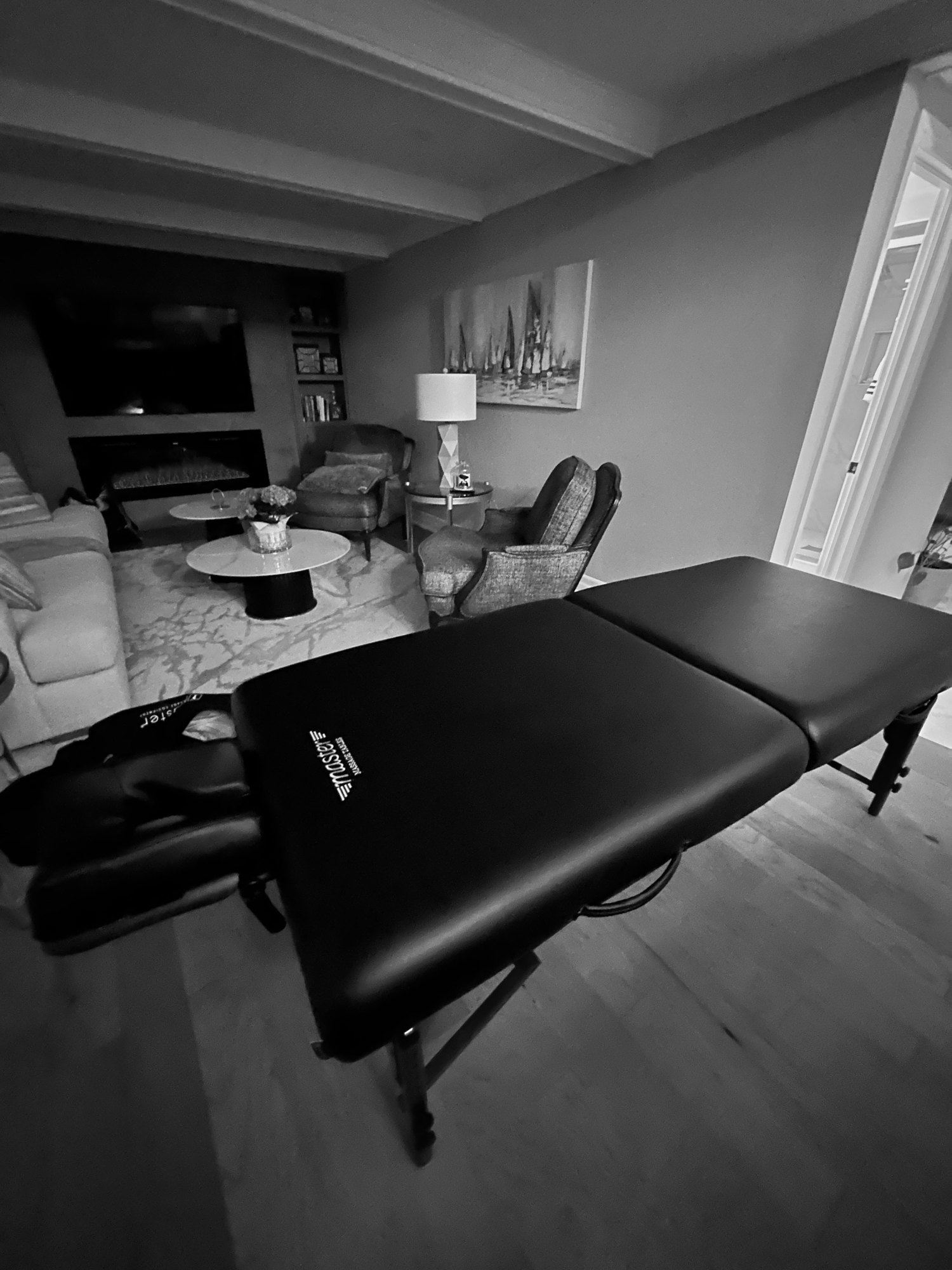 A HyperTherapy massage table set up in an office lounge for a corporate wellness day