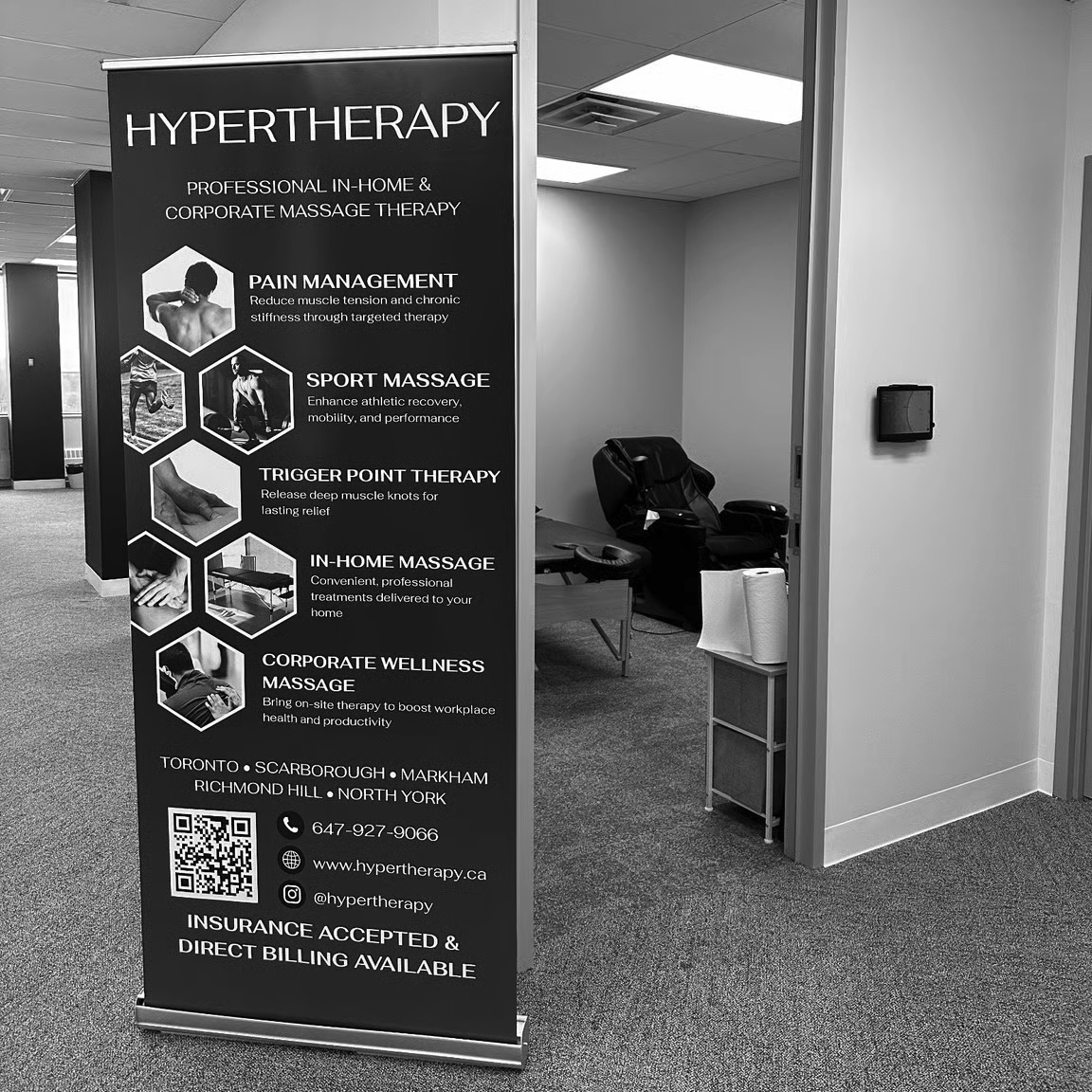 HyperTherapy banner and massage chair set up on-site at the Idealogical Group office