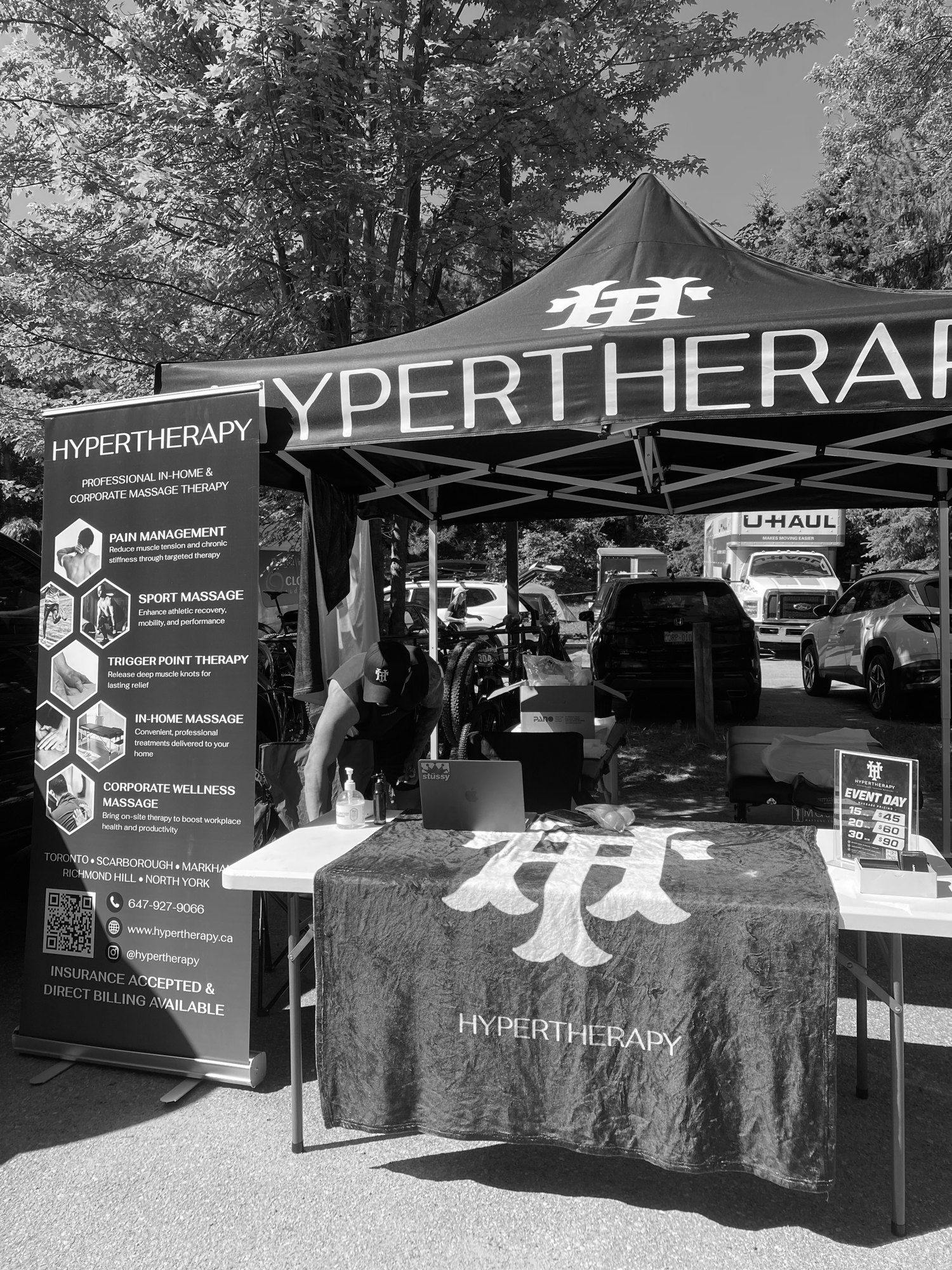 HyperTherapy's branded event tent and chair massage station set up and ready